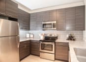 Thumbnail 2 of 21 - Model kitchen cabinetry at Fifth Street Place Apartments, Charlottesville, VA, 22903