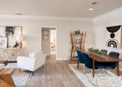 Thumbnail 3 of 30 - a living and dining room area with a wooden table and blue chairs at Appling Lakes, Cordova, Tennessee