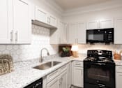 Thumbnail 1 of 30 - a kitchen with white cabinets and black appliances at Appling Lakes, Cordova, 38016