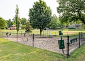 Thumbnail 27 of 30 - a fenced in dog park with a playground in the background at Appling Lakes, Cordova, TN, 38016