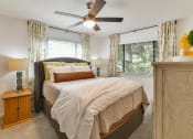 Thumbnail 4 of 19 - a bedroom with a bed and a ceiling fan at 1900 Rosemont, Roswell, 30076