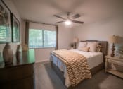 Thumbnail 5 of 19 - a bedroom with a large bed and a ceiling fan at 1900 Rosemont, Roswell