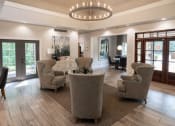 Thumbnail 15 of 19 - a living room with couches and chairs and a chandelier