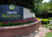 Thumbnail 19 of 19 - a brick retaining wall with a sign for rosenmont apartment homes
