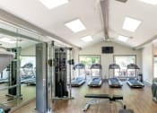 Thumbnail 9 of 19 - a gym with treadmills and other exercise equipment and windows at 1900 Rosemont, Roswell, 30076