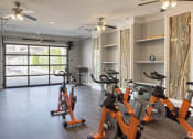 Thumbnail 20 of 30 - an indoor cardio room with exercise bikes and a window at Arlo Luxury homes Apartments, Little Rock, AR,72210