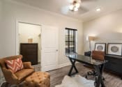 Thumbnail 9 of 30 - a living room with a desk and a chair  at Arlo Luxury homes Apartments, Little Rock, AR,72210
