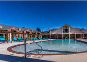 Thumbnail 14 of 30 - a resort style pool with lounge chairs around it  at Arlo Luxury homes Apartments, Arkansas