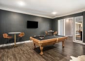 Thumbnail 19 of 30 - a games room with a pool table and a tv at Arlo Luxury homes Apartments, Little Rock, Arkansas