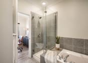 Thumbnail 8 of 30 - a bathroom with a shower and a tub at Arlo Luxury homes Apartments, Little Rock, 72210