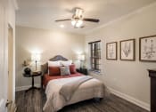 Thumbnail 5 of 30 - a bedroom with a bed and a ceiling fan  at Arlo Luxury homes Apartments, Little Rock, AR