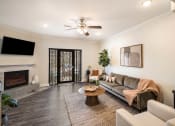 Thumbnail 4 of 30 - a living room with a couch and a fireplace at Arlo Luxury homes Apartments, Little Rock