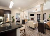 Thumbnail 3 of 30 - a kitchen and living room with a couch and a table at Arlo Luxury homes Apartments, Arkansas
