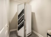 Thumbnail 24 of 30 - a small refrigerator in a small room in a room with white walls  at Arlo Luxury homes Apartments, Little Rock