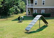 Thumbnail 22 of 28 - a seesaw in a yard with a house in the background at Ashby at Ross Bridge, Hoover