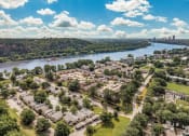 Thumbnail 20 of 21 - an aerial view of a city with a river and trees at Brightwaters Apartments, Little Rock, Arkansas