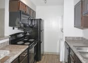 Thumbnail 14 of 21 - a kitchen with a stove and refrigerator and a sink at Brightwaters Apartments, Little Rock, AR,72202