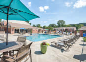 Thumbnail 15 of 21 - our apartments offer a swimming pool with tables and chairs at Brightwaters Apartments, Little Rock