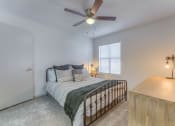 Thumbnail 8 of 21 - a bedroom with a bed at Brightwaters Apartments, Little Rock, AR