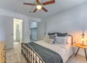 Thumbnail 10 of 21 - a bedroom with a bed and a ceiling fan at Brightwaters Apartments, Little Rock, 72202