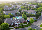 Thumbnail 25 of 31 - A bird's eye view of a residential area with houses and a swimming pool.