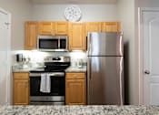 Thumbnail 3 of 35 - A kitchen with a stainless steel refrigerator, microwave, and oven. at Cambridge Square, Overland Park