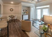 Thumbnail 5 of 31 - A modern living room with a glass coffee table and a white sofa.