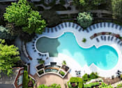 Thumbnail 22 of 31 - A swimming pool surrounded by trees and bushes.