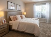 Thumbnail 6 of 31 - A bedroom with a large bed and two lamps.