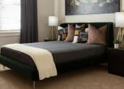 Thumbnail 9 of 14 - a bedroom with a bed and pillows at Esplanade District Apartments, Little Rock, AR