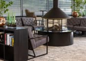 Thumbnail 5 of 14 - a living room with couches and chairs and a table with a lamp at Esplanade District Apartments, Little Rock, 72114