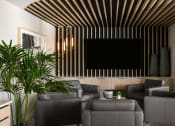Thumbnail 4 of 14 - a living room with couches and a tv on the wall at Esplanade District Apartments, Little Rock, Arkansas