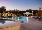 Thumbnail 10 of 14 - a swimming pool at night at the resort at governors island at Esplanade District Apartments, Little Rock, 72114