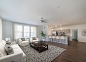 Thumbnail 4 of 21 - A living room with a white couch and a coffee table.