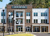 Thumbnail 19 of 21 - A street view of a building with the sign "Lareland Town Square" on it.