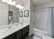 Thumbnail 13 of 34 - a bathroom with two sinks and a shower and a tub at Legends at Chatham, Savannah, GA