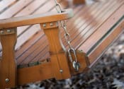 Thumbnail 27 of 34 - a wooden swing on the side of a bench at Legends at Chatham, Savannah, GA, 31405
