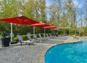 Thumbnail 16 of 34 - a swimming pool with umbrellas and chairs next to it at Legends at Chatham, Georgia, 31405