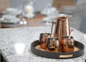Thumbnail 7 of 34 - a pitcher and three cups on a tray on a marble table at Legends at Chatham Apartments, Savannah
