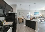 Thumbnail 3 of 34 - an open kitchen and living room with a couch and a table at Legends at Chatham, Savannah, GA, 31405