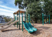 Thumbnail 28 of 34 - a playground with a play set and slides at Legends at Chatham, Savannah, GA