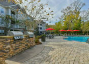 Thumbnail 17 of 34 - our apartments have a pool and a patio with umbrellas at Legends at Chatham Apartments, Savannah