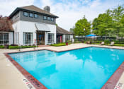 Thumbnail 13 of 24 - a swimming pool with a white building in the background at Lincoln at Wolfchase, Tennessee