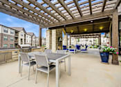 Thumbnail 14 of 29 - Patio with a Table and Chairs at McKenzie Park Apartments, Little Rock, AR, 72223