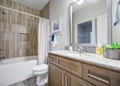 Thumbnail 8 of 29 - Bathroom with a White Tub at McKenzie Park Apartments, Arkansas