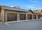 Thumbnail 24 of 28 - a garage with three garage doors in front of a house