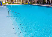 Thumbnail 16 of 28 - a large swimming pool at a hotel with blue water