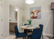 Thumbnail 28 of 28 - a dining room with a table and a painting of a cow