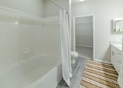 Thumbnail 9 of 23 - A white bathroom with a tub, toilet, and sink. at Madison Shelby Farms, Memphis