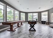 Thumbnail 54 of 58 - A room with a large table and chairs in the middle of it.